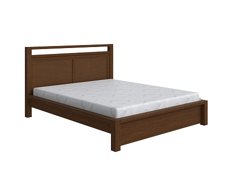 Коричневая кровать Fiord - Кровать из массива с декоративной резкой в изголовье.